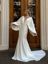 Fit and flare crepe wedding dress with cape sleeves