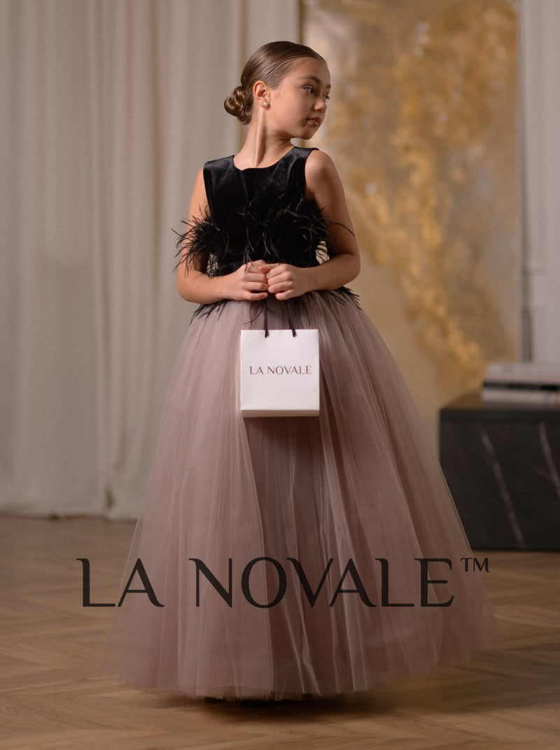 Elegant black velvet junior bridesmaid dress with ostrich feathers